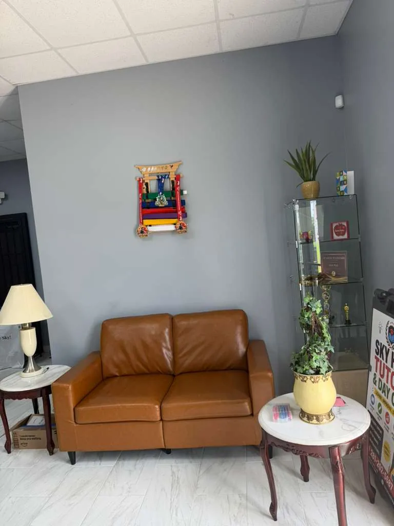 Comfortable parent waiting area with seating and student achievements on display